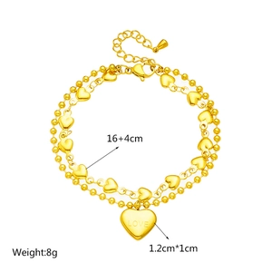 Double-layered golden titanium steel bracelet with heart pendant and round beads detail