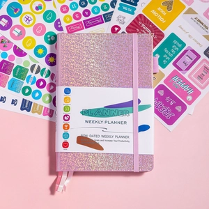 Detailed top view of pink glitter weekly planner with colorful functional stickers