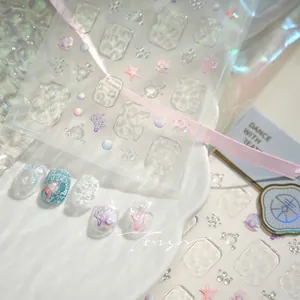 Close-up of 3D embossed ocean nail stickers with sea stars and water ripple texture