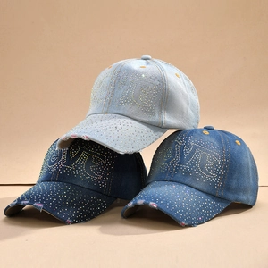 Distressed denim baseball caps with rhinestones in light, medium, and dark blue wash
