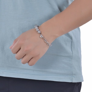Detail of beaded and silver chain bracelet featuring a heart magnetic clasp on wrist