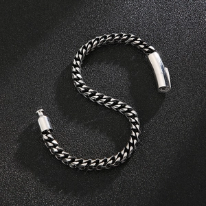 Close-up of silver titanium steel dragon bone chain bracelet with cylindrical clasp