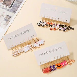 Macro shot of colorful Halloween theme enamel drop earrings with alloy hooks and spooky charms