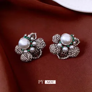 Elegant vintage French style flower stud earrings with faux pearls and green rhinestones