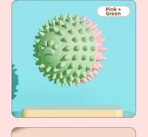 Close-up of pink and green TPR pet chew ball with paw prints and dental cleaning spikes