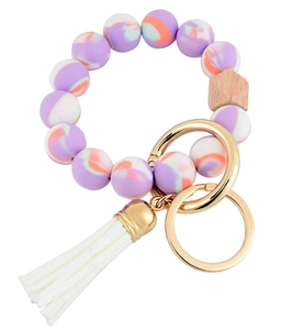 Detail of marble pattern silicone beads, hexagonal wood bead and white tassel keychain
