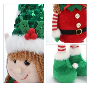 Close-up of sequined hat and embroidered face details on Christmas elf plush doll