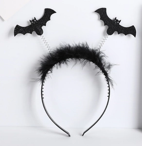 Detail of Halloween headband featuring black glittery bats, spring coils, and feather trim