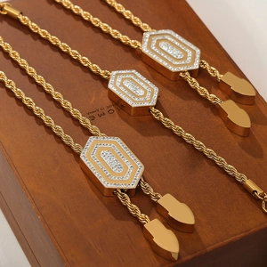 Elegant gold titanium jewelry set with hexagonal diamond pendant and twist chain