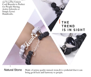 Detail of couple bracelets with magnetic heart buckle and natural lava and howlite stones