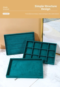 Detail of a dark green velvet jewelry tray set for organizing rings and earrings