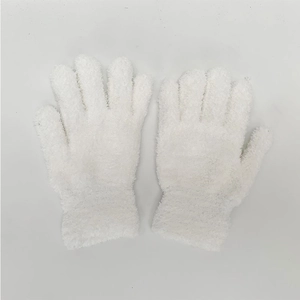Macro shot of fluffy white coral fleece winter gloves with elastic ribbed cuffs