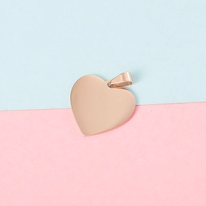 Detailed view of 25mm rose gold heart pendant with polished mirror finish on pink blue background