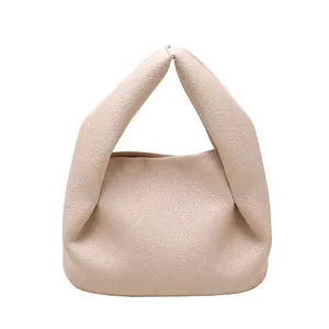 Minimalist beige ruched cloud handbag with pebble grain leather and folded handle design