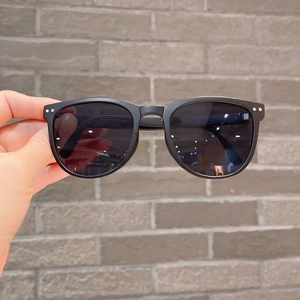 Close-up of kids black foldable sunglasses with dark gray polarized lenses and studs
