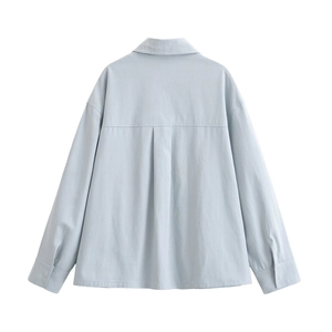 Detail view of the back pleat and premium stitching on this light blue long sleeve shirt