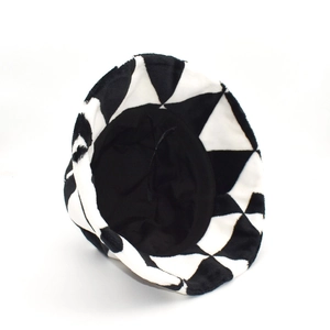 Winter plush bucket hat featuring black and white geometric triangle patchwork design