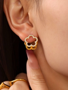 Close-up of 18K gold plated flower hoop earrings with zircon pavé edges on model