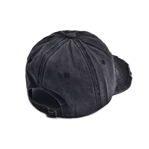 Detail of adjustable metal buckle and distressed frayed edge on dark grey baseball cap