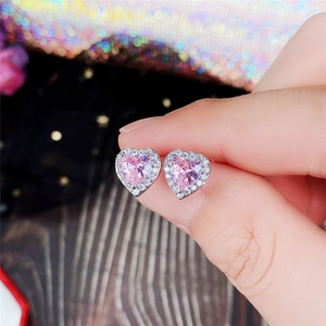 Detailed close-up of pink heart-shaped zircon earrings with micro-pave setting