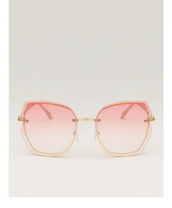 Detail showing oversized rimless geometric sunglasses with pink gradient lenses and gold frame