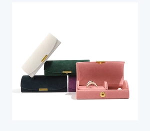 Macro detail of velvet jewelry travel cases in various colors with ring slots