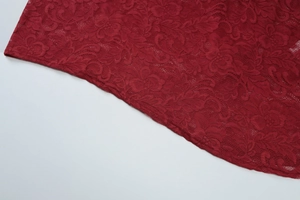 Close-up of intricate dark red floral lace fabric with hollow-out texture for summer dress