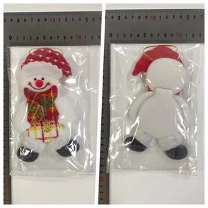 Detail view of snowman Christmas plush ornament with red hat and scarf for tree decor