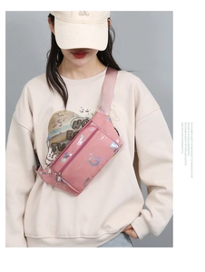 Detail of pink oxford waist bag with silver abstract print worn by a model