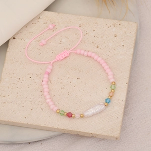 Handmade bohemian beaded bracelet with pink frosted beads and white baroque pearl charm