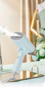 Detail of light blue foldable handheld garment steamer with a metallic steam soleplate