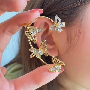 Detailed close-up of a gold butterfly ear cuff with sparkling rhinestones and crystals