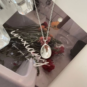Minimalist 925 sterling silver necklace with polished oval concave pendant on white card