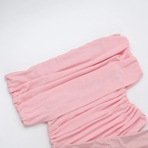 Macro detail of pink ruched fabric texture on this stylish off-shoulder dress