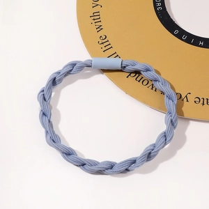 Detail of light blue triple-braid knotted hair tie with matching elastic connector