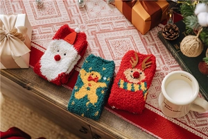 Festive Christmas coral fleece socks with elk and gingerbread man patterns in gift setting