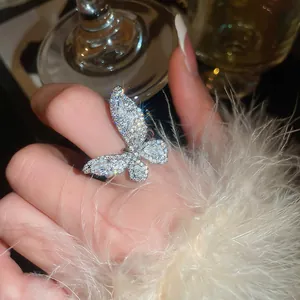 Elegant silver butterfly open ring with sparkling cubic zirconia on a female finger