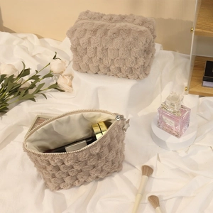 Plush checkerboard makeup bag with star zipper pull shown in open and closed views