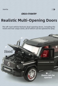 Detail view of black G-Class toy car with open doors, hood, and red interior seats
