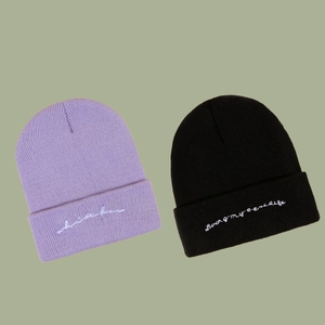 Autumn warm knitted beanies in purple and black with stylish white embroidered lettering