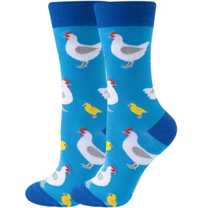 Detail of blue crew socks featuring cute white hen and yellow chick knitted patterns