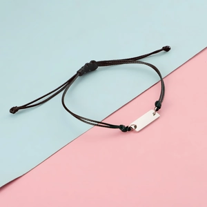Adjustable black braided rope bracelet with a polished silver rectangular metal bar pendant