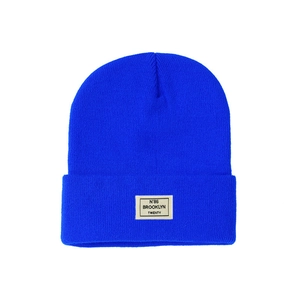 Detail of navy knit beanie showing the ribbed texture and Brooklyn N'86 woven label
