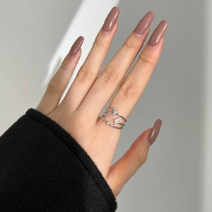 Macro detail of silver multi-layer ring featuring crescent moon and star zircon inlay