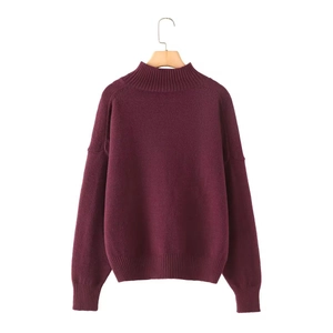 Detail of the soft knit texture and ribbed cuffs of this burgundy standing collar sweater