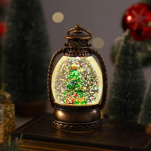 Close-up of retro bronze Christmas lantern with LED glowing tree and glitter on old books