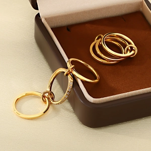 Elegant gold multi-layered ring with zircon stones on silk background for a luxury feel