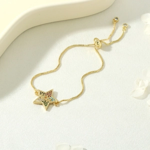 Macro detail of star-shaped MOM pendant with colorful zircon stones on gold chain