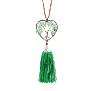 Detailed view of handmade green crystal tree of life heart pendant with elegant tassel