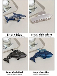 Detailed view of ocean-themed shark and whale acetate hair claws in various sizes